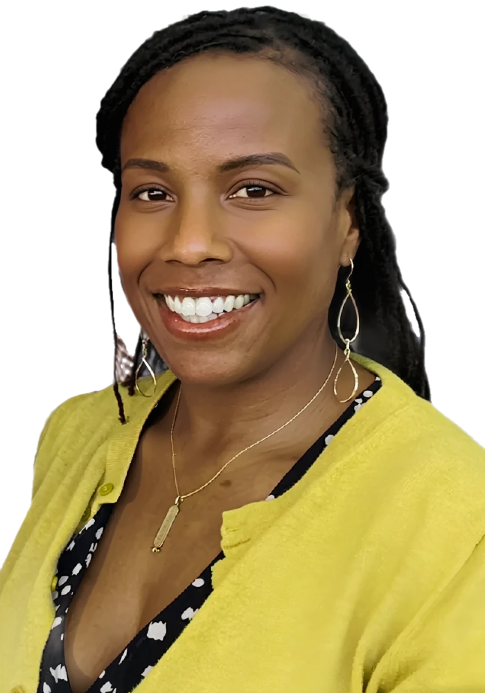 La Wanda Knox smiling in a mustard cardigan